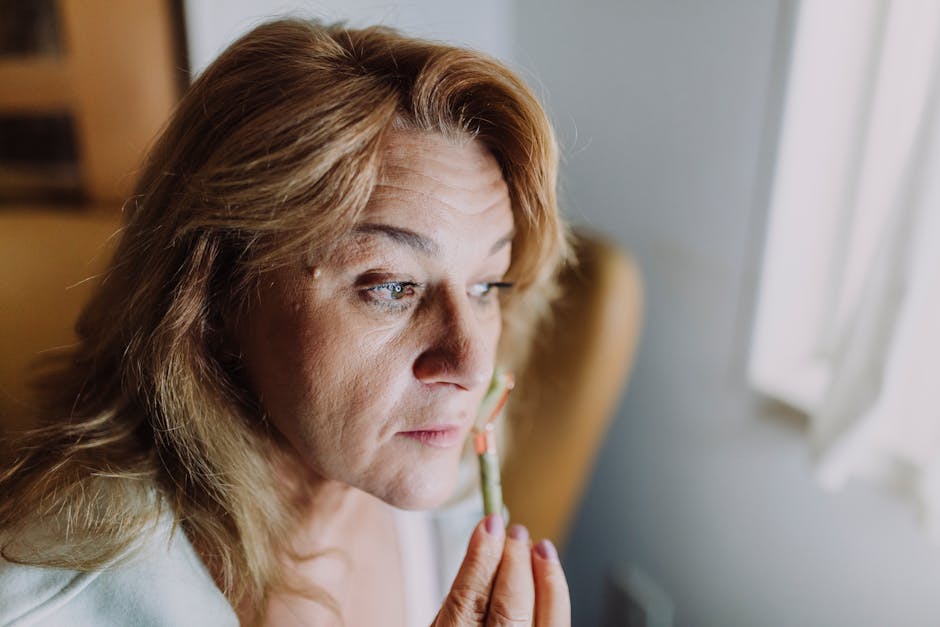 peaceful woman demonstrating gentle eye massage technique with fingers around eye area in natural lighting