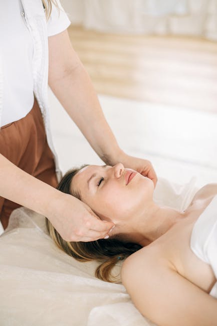 young woman gently massaging around her eyes with fingers in peaceful spa environment